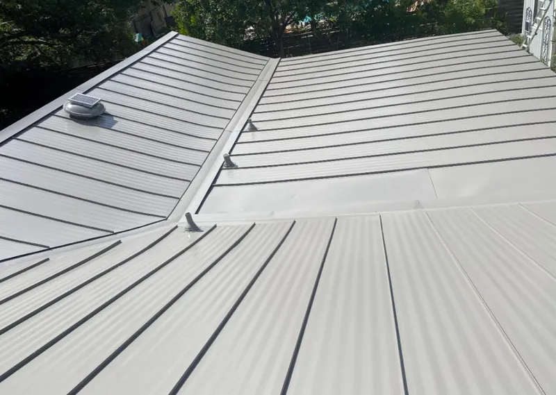 Solar attic fan installed on a metal roof for Roof Ventilation in Brookhaven